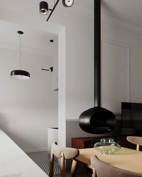 Nowoczesne minimalistyczne wnętrze z czarnym kominkiem wiszącym, drewnianym stołem, beżowymi krzesłami, białymi ścianami i czarnymi lampami wiszącymi.